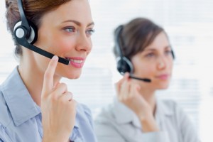 Call centre agents at work and smiling