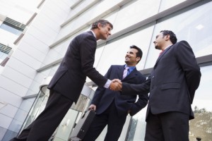 Business people shaking hands outside office